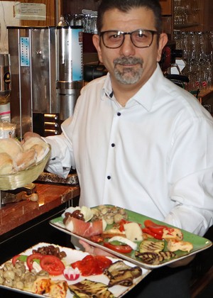 Vor Felicitas Hegemanns Vortrag über ihre siebenwöchige Rad-Reise durch Italien servierte Maurizio Cocina, Chef der Pizzeria 'Roma', den Gästen 'Antipasti Misto'. (Foto: Jens Gesper)