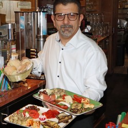 Vor Felicitas Hegemanns Vortrag über ihre siebenwöchige Rad-Reise durch Italien servierte Maurizio Cocina, Chef der Pizzeria „Roma“, den Gästen „Antipasti Misto“. (Foto: Jens Gesper)